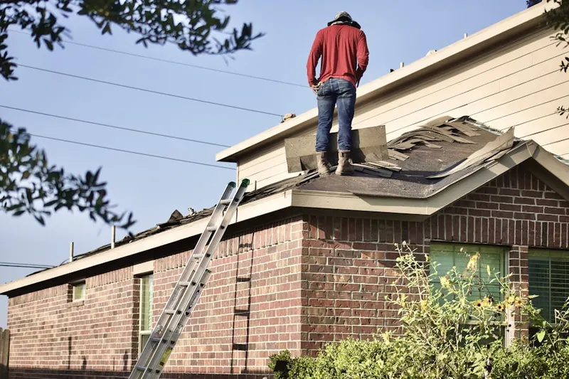 Professional roofer working on a residential roof in Central Visalia